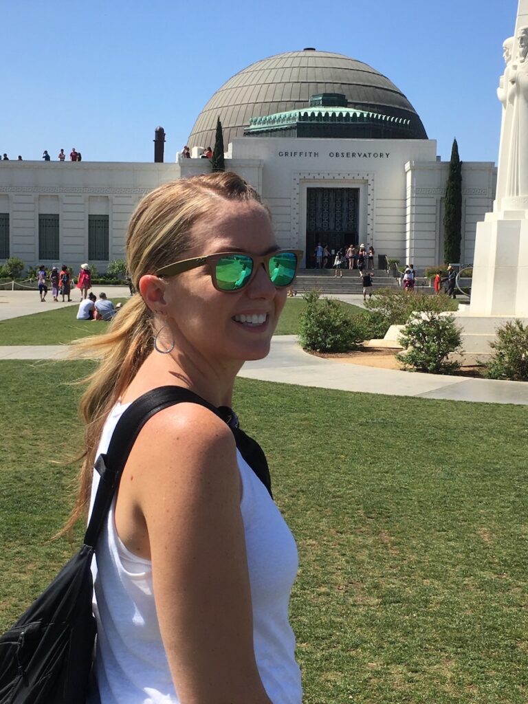 A woman standing outside of the Griffith Observatory