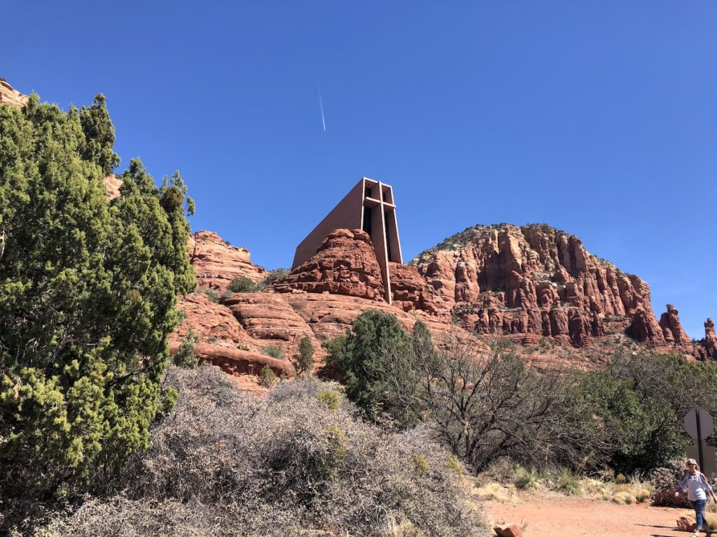 Chapel of the Holy Cross in Sedona, Arizona, from the perspective of the photographer looking up at the chapel's cross shaped facade.