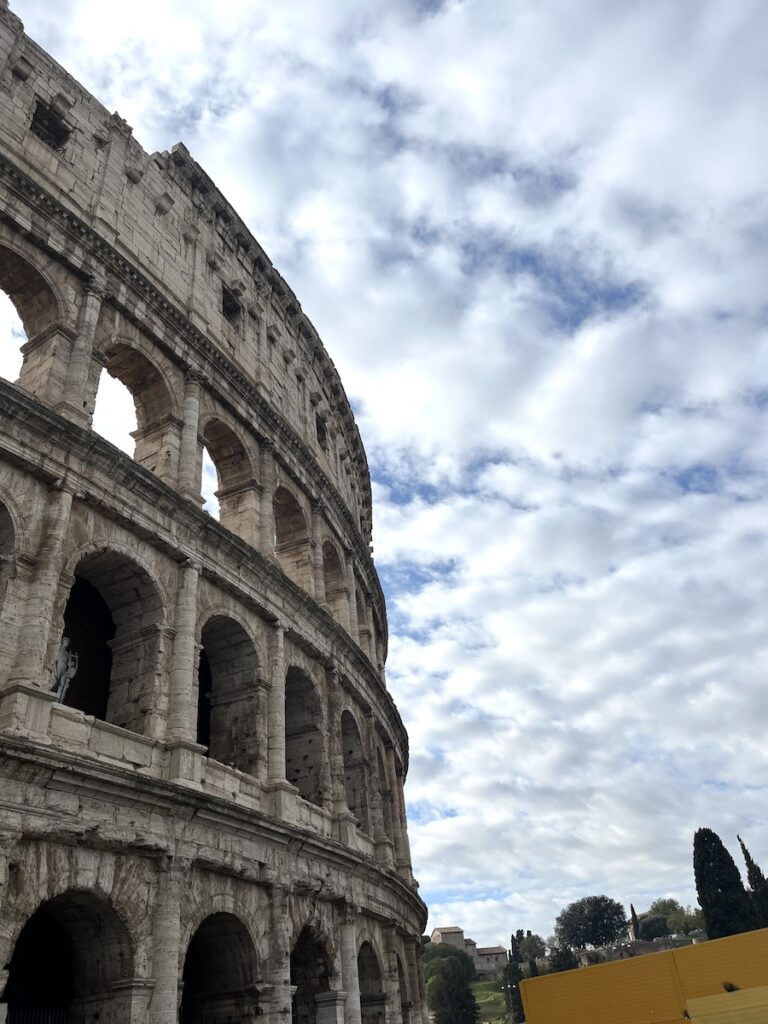 Everything you need to know to visit the Colosseum in Rome.

This photo shows some of the Colosseum structure in Rome with trees and sky in the background.